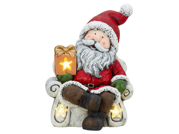 Mel-O-Design 3900 Nikolaus sitzend im Sessel mit Geschenk in der Hand & LED-Licht